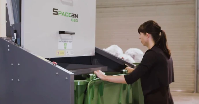 Operator loading suitable waste into a compatible commercial bin
